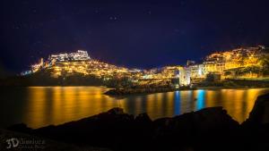 a view of a city at night at Best Western Hotel Blumarea in Castelsardo