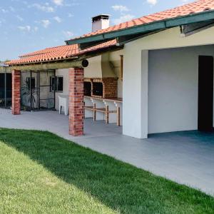 a house with a patio with a roof at Villa Royal Natura - Private Villa in Pombal in Pombal