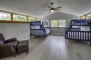 a room with three bunk beds and a couch at River Rats Rest in Homosassa