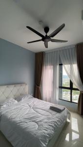 a bedroom with a bed with a ceiling fan at Tulips Cozy Homestay For You in Shah Alam +14 photos
