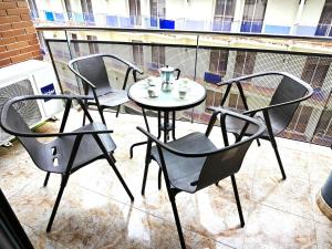 three chairs and a table on a balcony with a table and chairs at Seawolf Apartment, Lloret de Mar in Lloret de Mar
