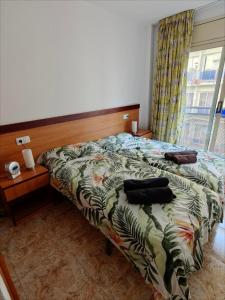 a bedroom with a bed and a window at Seawolf Apartment, Lloret de Mar in Lloret de Mar