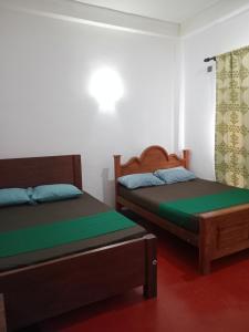 Postel nebo postele na pokoji v ubytování Lilly resort anuradapura