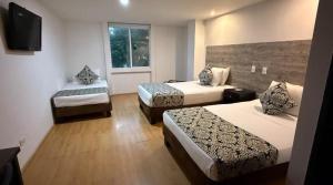 Voodi või voodid majutusasutuse Hotel Metropolis Plaza Cali toas