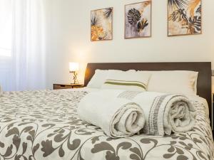 a bedroom with a large bed with a blanket on it at Center House Via Anghileri in Lecco +15 photos