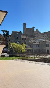 a view of a city with a castle in the background at La casa di Biba in Bolsena