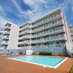 a large apartment building with a swimming pool in front of it at 210 Worchester St #405 in Ocean City
