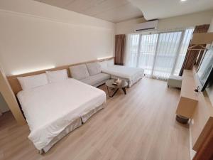 Postel nebo postele na pokoji v ubytování Cai Jyu B&B