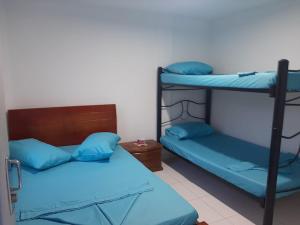 Postel nebo postele na pokoji v ubytování Hotel Los Delfines Melgar