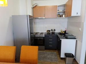 a kitchen with a refrigerator and a stove top oven at Mery's Corner in SJJ