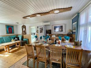 a dining room with a table and chairs at Villa Blue Heaven Pärnu in Pärnu