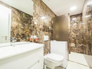 a bathroom with a toilet and a sink and a mirror at Luxury Apartment Valentina in Budva