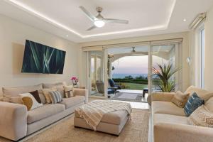 a living room with two couches and a ceiling fan at Infinity Pools & Sunsets Over Tamarindo Bay in Tamarindo +22 photos