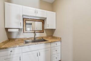 a kitchen with white cabinets and a sink at The Grand Horizon in Vail +53 photos