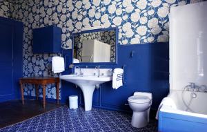 a blue bathroom with a sink and a toilet at Château d'Argoules, Baie de Somme près de la mer in Argoules +74 photos