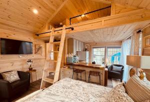 a bedroom with a loft bed in a log cabin at Cheerful Cottage with Loft 9 in Edgecomb