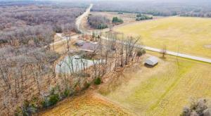 an overhead view of a field with a house and a road at Winding Woods Lodge in Clinton