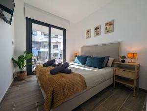 a bedroom with a bed with blue pillows on it at Luxurious new flat with pool & big terrace in Villamartin