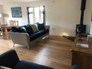 a living room with a couch and a table at Caretakers Hideaway in Puncknowle