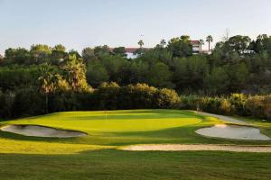 a view of a golf course with a green at Luxurious new flat with pool & big terrace in Villamartin