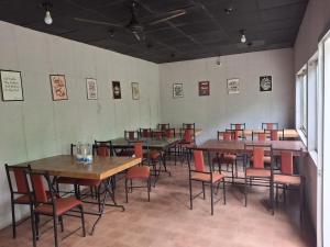 a room with tables and chairs in a restaurant at Green Park Tea Resort Sreemangal in Sreemangal