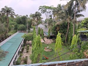 a view of the garden from the balcony of a house at Green Park Tea Resort Sreemangal in Sreemangal