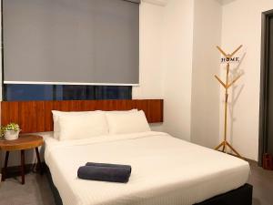 a bedroom with a bed with a black towel on it at Melaka Relax Home - 6 pax - SeaView corner unit - 6 min to Historical Spot & Jonker in Melaka +45 photos