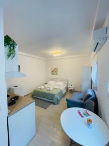 a living room with a bed and a table at Studio 87 in Rhodes Town