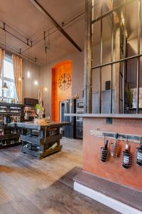 a large room with a kitchen with a large clock on the wall at Bahnhofsromantik trifft Luxus - Alter Bahnhof von Kruft in Kruft