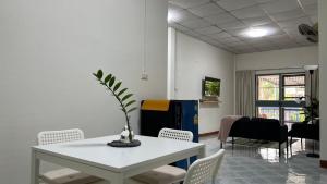 a room with a white table and chairs and a table and a table at BB Sweet Home in Ban Hin Kong (1)