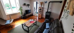 a living room with a couch and a coffee table at Gite au Petit Verger in Masevaux