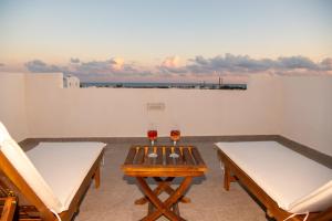 a room with two tables and two glasses of wine at DENIS Summer Living in Perivolos