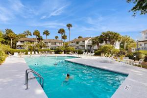 a person in a swimming pool at a resort at 40 Lagoon Villa in Isle of Palms