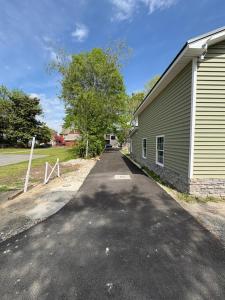 a road next to a building next to a tree at The Coastal Court Circle Apartment Sports Beach and Shopping in Georgetown