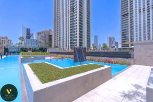 une piscine dans une ville avec de grands bâtiments dans l'établissement DOWNTOWN VIEWS II - VOGUE One Bedroom Apartment with Balcony, 42nd Floor Opposite Dubai Mall Skybridge, à Sabkhah