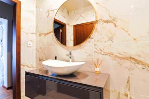 a bathroom with a sink and a mirror at Casa Vale do Luar in Celorico de Basto +34 photos