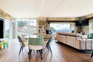 a living room with a table and chairs and a couch at Casa Vale do Luar in Celorico de Basto