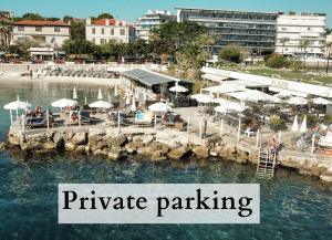 a pier with umbrellas and the words private parking at Royal Antibes - Luxury Hotel, Résidence, Beach & Spa in Antibes