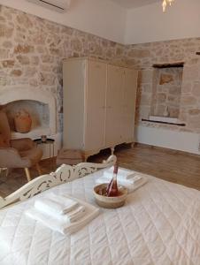 a living room with a bed and a fireplace at Tselekos House Old renovated stone house crete in Galiá