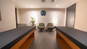 a waiting room with two chairs and a table at Park Inn by Radisson Yalova City Center in Yalova +70 photos