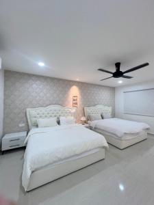 a bedroom with two beds and a ceiling fan at BungalowD Pool Villa 7R6B with Netflix Enjoyable Movies & Dramas in Ipoh +22 photos