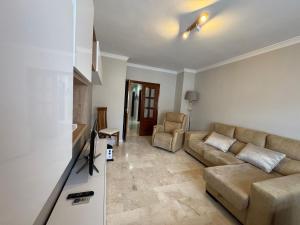 a living room with a couch and a tv at Encarnación 11 in Antequera