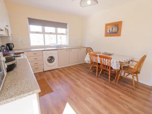 eine Küche und ein Esszimmer mit Tisch und Stühlen in der Unterkunft Hill House in Ballymoney + 9 Fotos