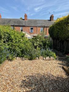 a garden in front of a brick house at Terraced Garden House Three Bedrooms in Stamford