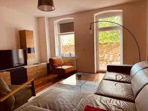 a living room with a couch and a tv at Moderne Wohnung in Eberswalde in Eberswalde
