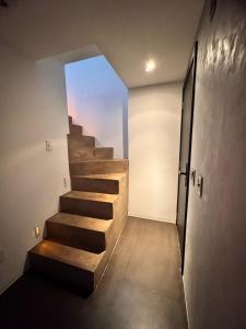 a stairway leading to a room with a window at Apto de Luxo Loft Duplex em área nobre na Doca in Belém