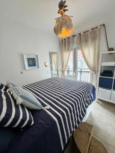 a bedroom with a blue and white striped bed at Bleu Mati in Kokkari