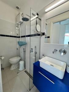 a bathroom with a sink and a glass shower at Bleu Mati in Kokkari +39 photos