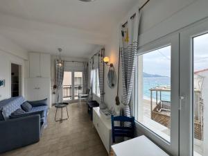 a living room with a view of the ocean at Bleu Mati in Kokkari