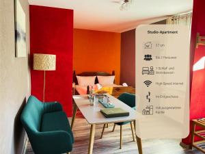 a room with a table and chairs and a bed at Trattoria & Apartments - Casa da Enzo in Goslar